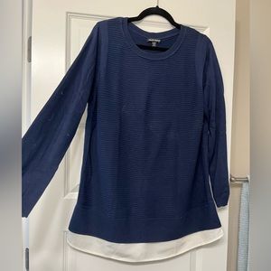 Women’s pull over sweater blouse. Navy blue with white blouse detail at hem.